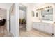 Bright bathroom featuring a white vanity with modern lighting and a shower with a cactus-themed curtain at 384 Teal Ct, Roswell, GA 30076
