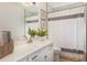 Well-lit bathroom features a white vanity, modern fixtures, and a shower with a striped curtain at 384 Teal Ct, Roswell, GA 30076