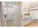 Open view to bathroom with white vanity, modern fixtures, and a shower with a striped curtain at 384 Teal Ct, Roswell, GA 30076