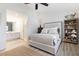 Spacious bedroom featuring a cozy bed, bookshelf, and a partial view of an adjacent bathroom at 384 Teal Ct, Roswell, GA 30076