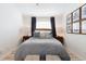 Inviting bedroom with a plush bed, coastal-themed decor, and natural light from the window at 384 Teal Ct, Roswell, GA 30076