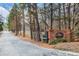 Community entrance sign with brick pillar, black fence, and landscaping at Martin's Landing Residential Community at 384 Teal Ct, Roswell, GA 30076