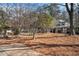 Beautiful home exterior featuring manicured lawn, mature trees, and covered porch at 384 Teal Ct, Roswell, GA 30076