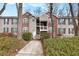 Inviting condo complex featuring brick accents, mature landscaping, and a charming walkway at 384 Teal Ct, Roswell, GA 30076