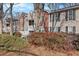 Multi-unit condo featuring red brick accents, neutral siding, and well-maintained landscaping at 384 Teal Ct, Roswell, GA 30076