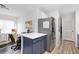 Cozy kitchen features stainless steel appliances and an adjacent office space with great natural light at 384 Teal Ct, Roswell, GA 30076