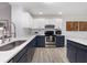 Updated kitchen featuring white countertops, two-tone cabinets, and stainless steel appliances at 384 Teal Ct, Roswell, GA 30076