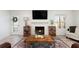 Comfortable living room with a fireplace, hardwood floors, and access to the front door at 384 Teal Ct, Roswell, GA 30076