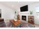 Cozy living room with fireplace, hardwood floors, and views to exterior at 384 Teal Ct, Roswell, GA 30076