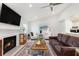 Bright living room with fireplace, vaulted ceiling, ceiling fan and hardwood flooring at 384 Teal Ct, Roswell, GA 30076