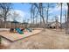 Community playground with slides and swings with a house in the background at 384 Teal Ct, Roswell, GA 30076