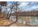 Scenic river view showing the natural beauty of the community, with sun shining through bare winter trees at 384 Teal Ct, Roswell, GA 30076