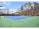 Community tennis courts feature well-maintained green and blue surfaces, surrounded by trees at 384 Teal Ct, Roswell, GA 30076
