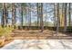 A spacious backyard with a wood fence and mature trees, providing privacy and a natural setting at 3850 Laurel Nw Dr, Acworth, GA 30101