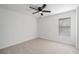 A minimalist bedroom features neutral carpet, a ceiling fan, and a bright window at 3850 Laurel Nw Dr, Acworth, GA 30101