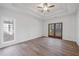 Bright bedroom with tray ceiling, hardwood floors and a view to the outdoors at 3850 Laurel Nw Dr, Acworth, GA 30101