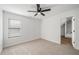 Bright bedroom features neutral carpet, a ceiling fan, and a bright window at 3850 Laurel Nw Dr, Acworth, GA 30101
