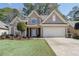 Charming home with a well-manicured lawn, a two-car garage, and a classic stucco facade at 3850 Laurel Nw Dr, Acworth, GA 30101