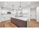 Stylish kitchen with white cabinets, stainless steel appliances, a trendy island, and modern pendant lighting at 3850 Laurel Nw Dr, Acworth, GA 30101