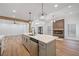 Open concept kitchen with island, white cabinets, stainless steel appliances, and a fireplace feature wall at 3850 Laurel Nw Dr, Acworth, GA 30101