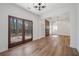 Open-concept living room with wood floors, fireplace, and double doors leading to the outdoors at 3850 Laurel Nw Dr, Acworth, GA 30101