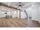 Open-concept living room with hardwood floors, wooden beams, a staircase, and white walls at 3850 Laurel Nw Dr, Acworth, GA 30101