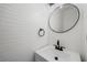 Charming powder room with shiplap walls, modern round mirror, and vanity at 3850 Laurel Nw Dr, Acworth, GA 30101