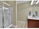 Bathroom features a glass shower and wood cabinets with a white countertop and sink at 509 Sawnee Corners Dr, Cumming, GA 30040
