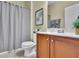 Bathroom featuring a shower with a curtain, a toilet, and a vanity with storage at 509 Sawnee Corners Dr, Cumming, GA 30040