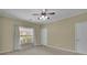 Neutral bedroom featuring plush carpet, a ceiling fan, and a window with natural light at 509 Sawnee Corners Dr, Cumming, GA 30040