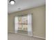 Bedroom with neutral walls, carpet flooring, ceiling light, and large window with blinds at 509 Sawnee Corners Dr, Cumming, GA 30040