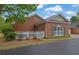 Charming brick home featuring a white picket fence and manicured landscaping at 509 Sawnee Corners Dr, Cumming, GA 30040
