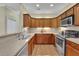 Functional kitchen featuring stainless steel appliances and updated cabinets at 509 Sawnee Corners Dr, Cumming, GA 30040