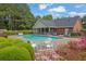 Community pool with ample seating, mature landscaping, and a covered picnic area for resident enjoyment at 509 Sawnee Corners Dr, Cumming, GA 30040