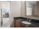 Bathroom sink vanity and mirror next to an open doorway with a city view at 1080 Peachtree Ne St # 2515, Atlanta, GA 30309