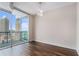 Bedroom with wood flooring and great city view through glass doors at 1080 Peachtree Ne St # 2515, Atlanta, GA 30309