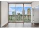 Bedroom features hardwood floors and floor-to-ceiling windows with expansive city views at 1080 Peachtree Ne St # 2515, Atlanta, GA 30309