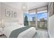 Cozy bedroom with a plush queen bed, skyline views from the large windows, and stylish decor create a serene urban retreat at 1080 Peachtree Ne St # 2515, Atlanta, GA 30309