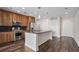 Contemporary kitchen with granite countertops, stainless steel appliances, an island with seating, and sleek cabinetry, adjacent to entryways at 1080 Peachtree Ne St # 2515, Atlanta, GA 30309