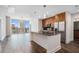 Modern kitchen featuring an island, stainless steel appliances, and dark hardwood floors, bathed in natural light and open to skyline views at 1080 Peachtree Ne St # 2515, Atlanta, GA 30309