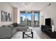 Stylish living room with contemporary furnishings, hardwood floors, and skyline views through expansive windows, perfect for urban living at 1080 Peachtree Ne St # 2515, Atlanta, GA 30309