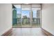 Bright living room boasts wood floors and sliding glass doors with a stunning city view at 1080 Peachtree Ne St # 2515, Atlanta, GA 30309