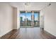 A bright living space with hardwood floors, skyline views through expansive windows, and modern lighting provides comfortable urban living at 1080 Peachtree Ne St # 2515, Atlanta, GA 30309