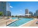Resort-style pool area with comfortable lounge chairs and stunning city views at 1080 Peachtree Ne St # 2515, Atlanta, GA 30309