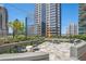Enjoy city views from this rooftop deck featuring modern seating and lush landscaping at 1080 Peachtree Ne St # 2515, Atlanta, GA 30309