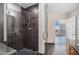 Spacious tiled shower with glass door and floor-to-ceiling tile and view of city skyline at 1080 Peachtree Ne St # 2515, Atlanta, GA 30309
