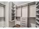Custom walk-in closet with shelving, drawers, and ample storage space for an organized wardrobe at 1080 Peachtree Ne St # 2515, Atlanta, GA 30309