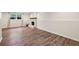 Large basement with faux wood flooring, a white brick fireplace, natural light from the window, and modern paint at 125 Roswell Farms Ln, Roswell, GA 30075
