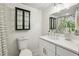 Bathroom with white vanity, decorative mirror, black accents, patterned shower curtain, and a modern sink faucet at 125 Roswell Farms Ln, Roswell, GA 30075