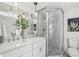 Bathroom featuring dual vanity, framed mirrors, glass shower, modern fixtures, and white and gray walls at 125 Roswell Farms Ln, Roswell, GA 30075